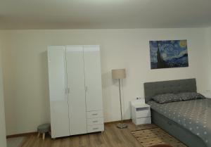 ein Schlafzimmer mit einem weißen Schrank neben einem Bett in der Unterkunft BELLEVUE in Narva