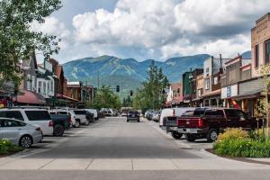 a street in a small town with parked cars at Downtown Whitefish awaits you at Central Ave Suite in Whitefish