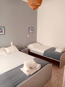 a bedroom with two beds with towels on them at Acheron rooms in Preveza