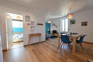 a living room and dining room with a table and chairs at La Belle Rive du voyageur in Bellerive-sur-Allier