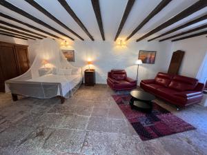 a bedroom with a bed and a couch and chairs at La Mareta Family Finca in Agaete