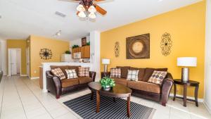 a living room with two couches and a table at The Pool Shack in Orlando