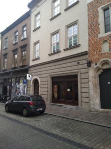 a black car parked in front of a building at Vinfort Aparthotel in Krakow