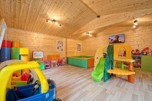 a childs room with a play room with a slide at RODOS Rowy Domki nad morzem in Rowy