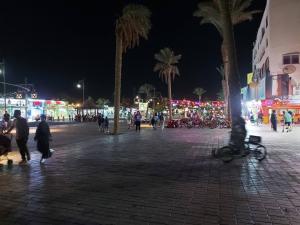 a group of people walking on a street at night at Horizon on Mamsha 2 in Hurghada +7 photos
