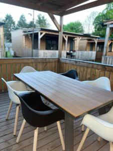 a wooden table and chairs on a deck at Nord mobile house in Velenje