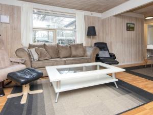 a living room with a couch and a coffee table at 10 person holiday home in Glesborg in Fjellerup Strand