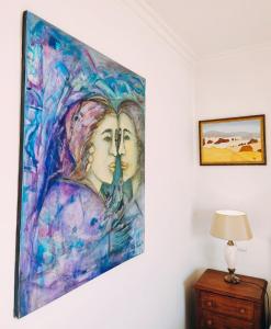 a painting of two women on a wall at Varanda do Outeiro in Melgaço