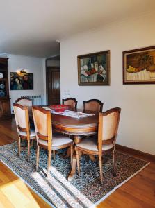 a dining room with a wooden table and chairs at Varanda do Outeiro in Melgaço