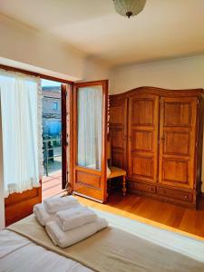a bedroom with a bed and a large window at Varanda do Outeiro in Melgaço +17 photos