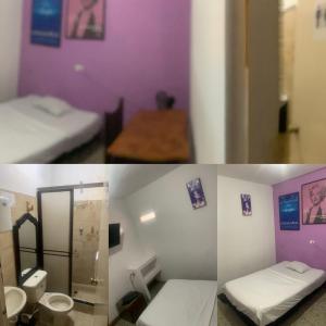 een kamer met 2 bedden en een kamer met een badkamer bij La Clave Hostel in Cali