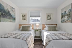 a bedroom with two beds and a window at Light Bright Stylish PRIVATE Home - Whitworth in Spokane +32 photos