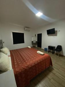 a hotel room with a bed and a flat screen tv at Hotel Sevilla Paraíso in Paraíso +5 photos