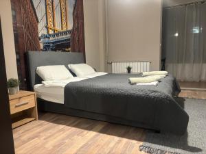 a bedroom with a bed with two pillows on it at Downtown Parliament in Belgrade