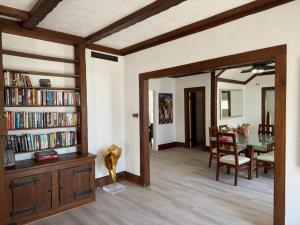 a living room with a table and a dining room at Turn of the Century Estate, Sauna Secluded in Memphis