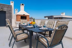 a black table and chairs on a patio at Luxury with jacuzzy on a private roof terrace in Nin