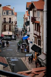 a city street with buildings and people walking on the street at ALFRED HOTELS Port-Vieux - Ex Georges VI in Biarritz