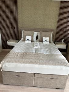 a bedroom with a large bed with two pillows at Belgrade Waterfront-Beograd na vodi Galaxy Apartment in Belgrade