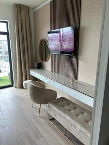 a living room with a couch and a tv on a wall at Belgrade Waterfront-Beograd na vodi Galaxy Apartment in Belgrade