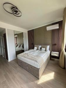 a bedroom with a large bed and a large mirror at Belgrade Waterfront-Beograd na vodi Galaxy Apartment in Belgrade