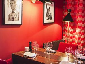 a table in a restaurant with wine glasses on it at Hôtel des Dromonts by SOWELL COLLECTION in Avoriaz