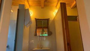 a bathroom with a sink and a mirror on the wall at Cabaña Mafer in Guatavita