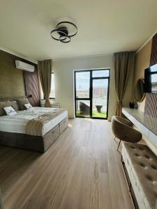 a large bedroom with a bed and a large window at Belgrade Waterfront-Beograd na vodi Galaxy Apartment in Belgrade