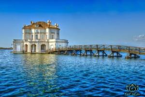 a house on the water next to a bridge at Al GeChiGiù in Bacoli