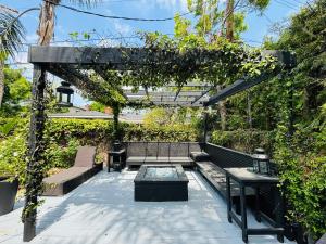 a pergola with a bench and a table at Charming Duplex Home in Sherman Oaks in Los Angeles