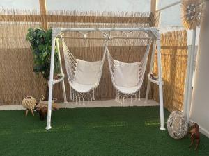 two hammocks on a patio with green grass at Summer Diamond in Kremasti