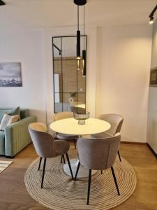 a table and chairs in a living room at Julis Apartment in Zlatibor