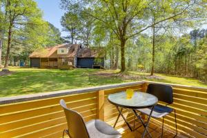 a patio with a table and chairs on a porch at Georgia Tiny Home on Farm Retreat Hike On-Site! in Lithonia