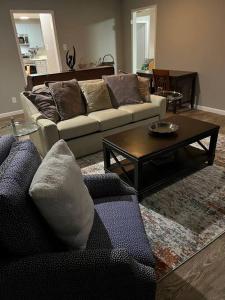 a living room with a couch and a coffee table at Chic Rancher 7BR Compound Near Graceland & Airport in Memphis