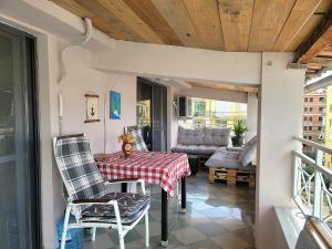 a porch with a table and chairs and a couch at SUNTAN Lovely Apartment in Golem