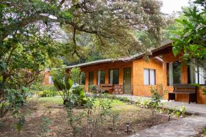 a house with a garden in front of it at Elida Lodge Monteverde in Monteverde Costa Rica
