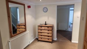 a room with two dressers and a mirror on a wall at Little Harbour Self Catering in Stanley