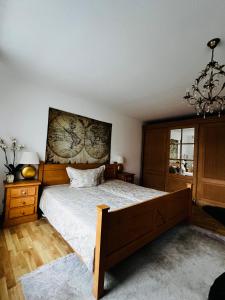 a bedroom with a large bed and a chandelier at Exklusives Haus mit Garten in Hannover
