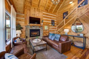 a living room with a couch and a fireplace at Autumns Peak in Sevierville