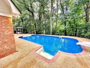 a swimming pool in the backyard of a house at Peaceful & Elegant Sleeps 16 with Pool Near Mall in Memphis