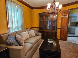 a living room with a couch and a table at Peaceful & Elegant Sleeps 16 with Pool Near Mall in Memphis
