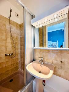 a bathroom with a sink and a shower at Le Cabieu in Ouistreham