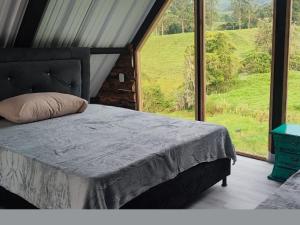 Postel nebo postele na pokoji v ubytování Hotel Chalet en montaña Manizales