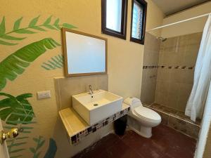 a bathroom with a sink and a toilet at Hotel Panajachel Oasis in Panajachel