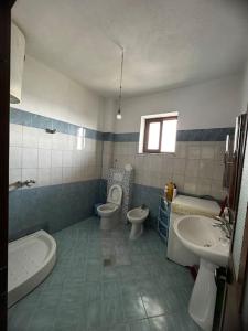 a bathroom with a sink and a toilet and a tub at Villa For Rent in Durrës