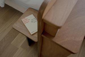 a book sitting on top of a wooden bench at ALFRED HOTELS Les Halles - Ex Hotel Anjou in Biarritz