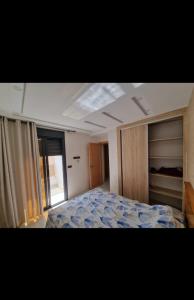 a bedroom with a bed and a large window at La belle vie in Berkawe