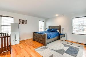 a bedroom with a bed in a room with white walls at Modern Elizabeth Apartment about 1 Mi to Train Station in Elizabeth