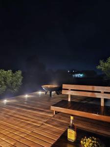 a couple of benches sitting on a deck at night at Villa Tropicale Fy in Mahajanga