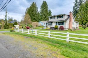 a white fence in front of a house at Charming Updated Retreat Walk to Lake Stevens! in Lake Stevens