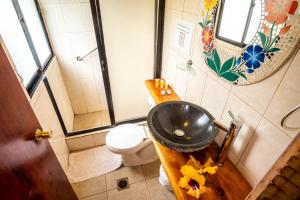 a bathroom with a sink and a toilet at Hotel Chez Maria Goretti in Hanga Roa